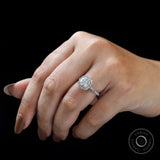 On-hand view of cushion cluster halo ring highlighting halo sparkle