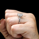 Angled view of radiant solitaire engagement ring on finger