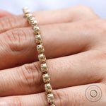 Side angle showing matte gold finish and floating stone setting