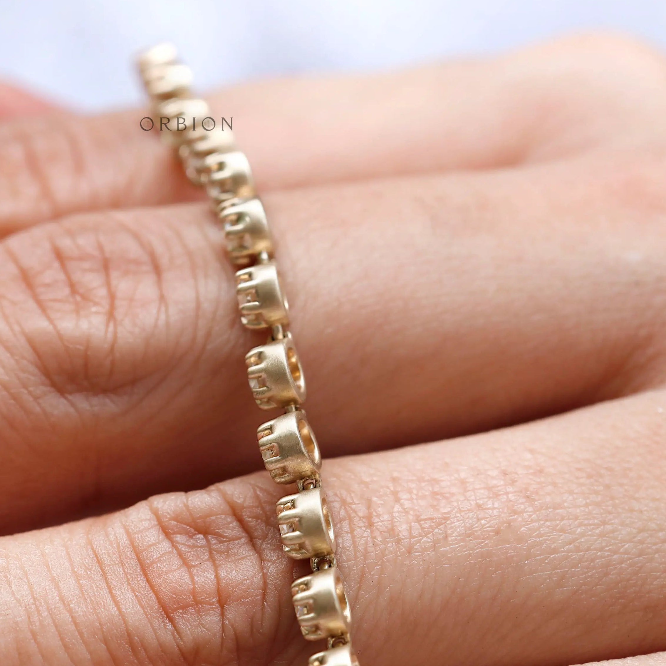 Side angle showing matte gold finish and floating stone setting