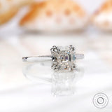 Profile view of Asscher cut Moissanite solitaire ring in 14K white gold on a neutral background.