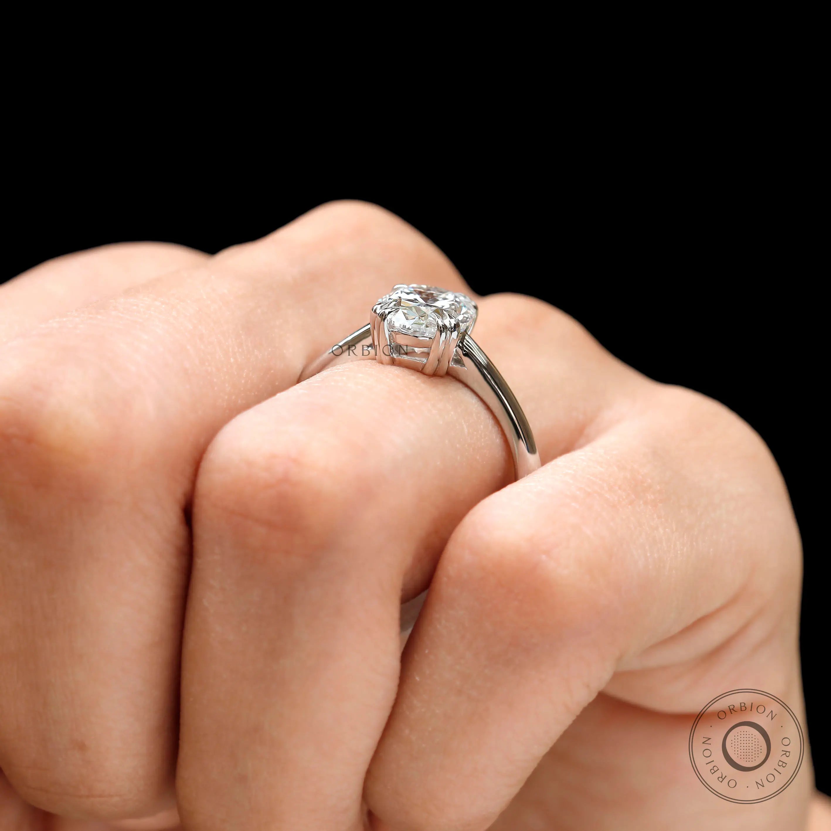 Four-prong oval solitaire ring in high polish white gold