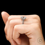 Oval solitaire ring photographed on hand