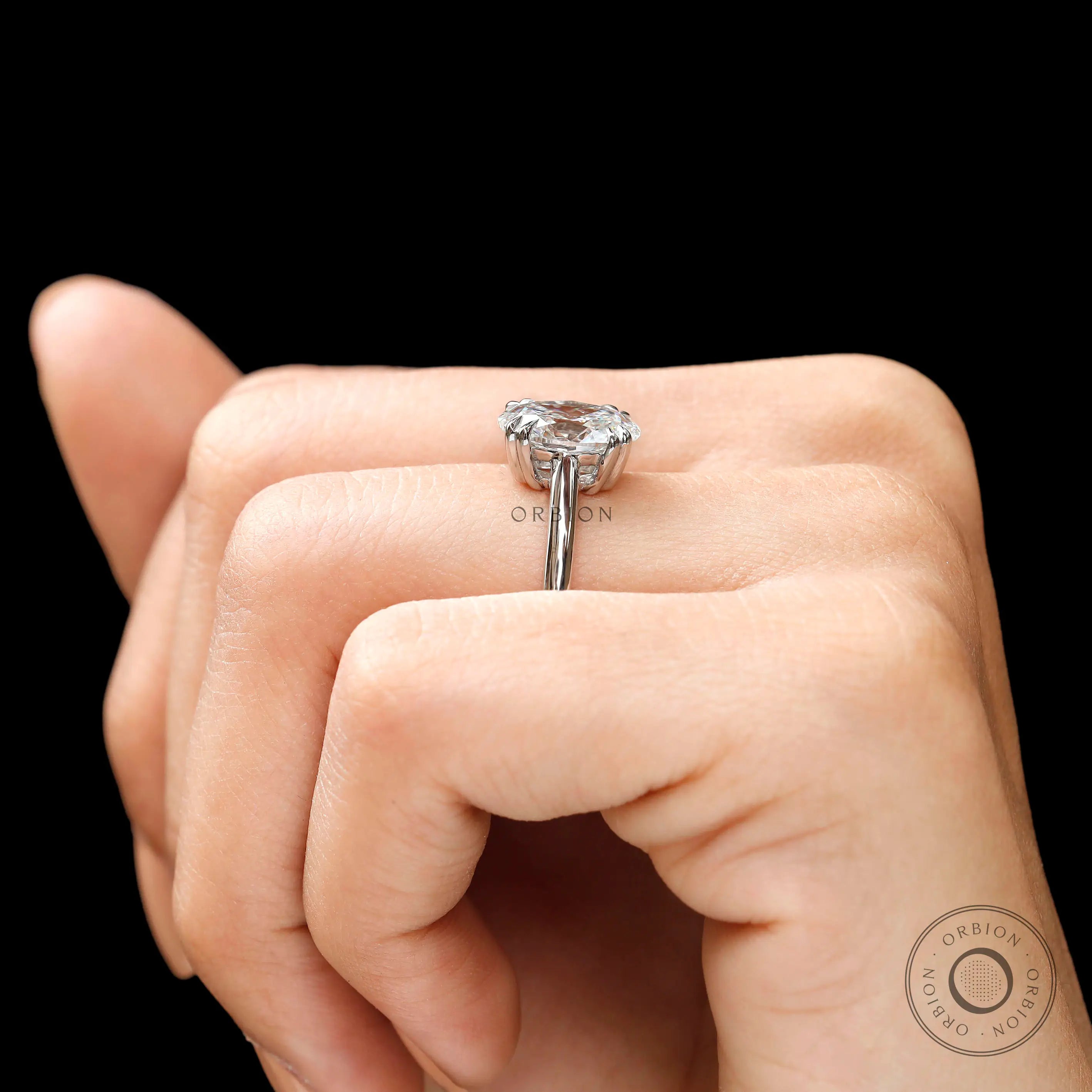 Oval solitaire ring photographed on hand
