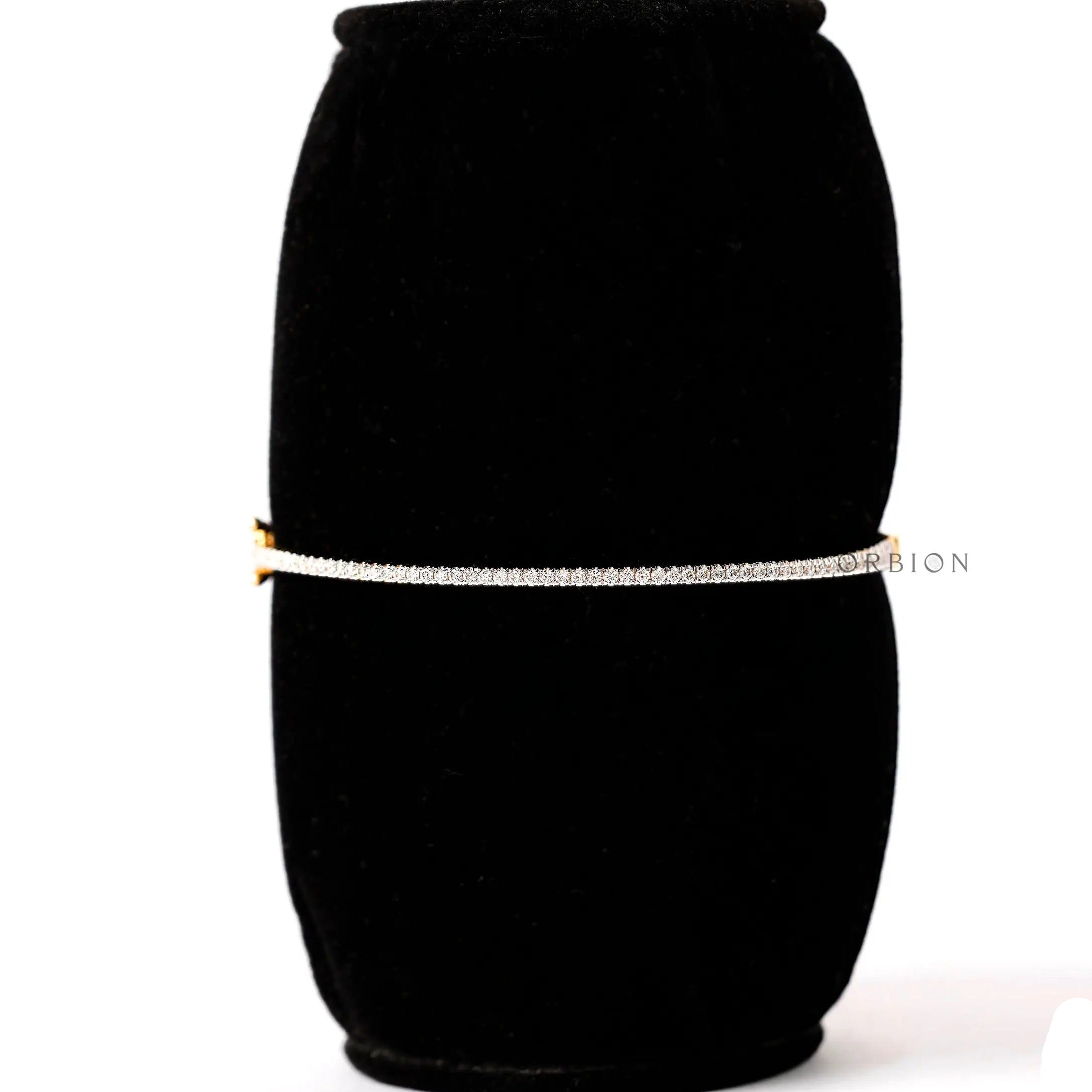 Dainty lab grown diamond bangle bracelet displayed on black stand
