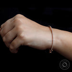 Dainty diamond bangle bracelet worn on wrist for size reference