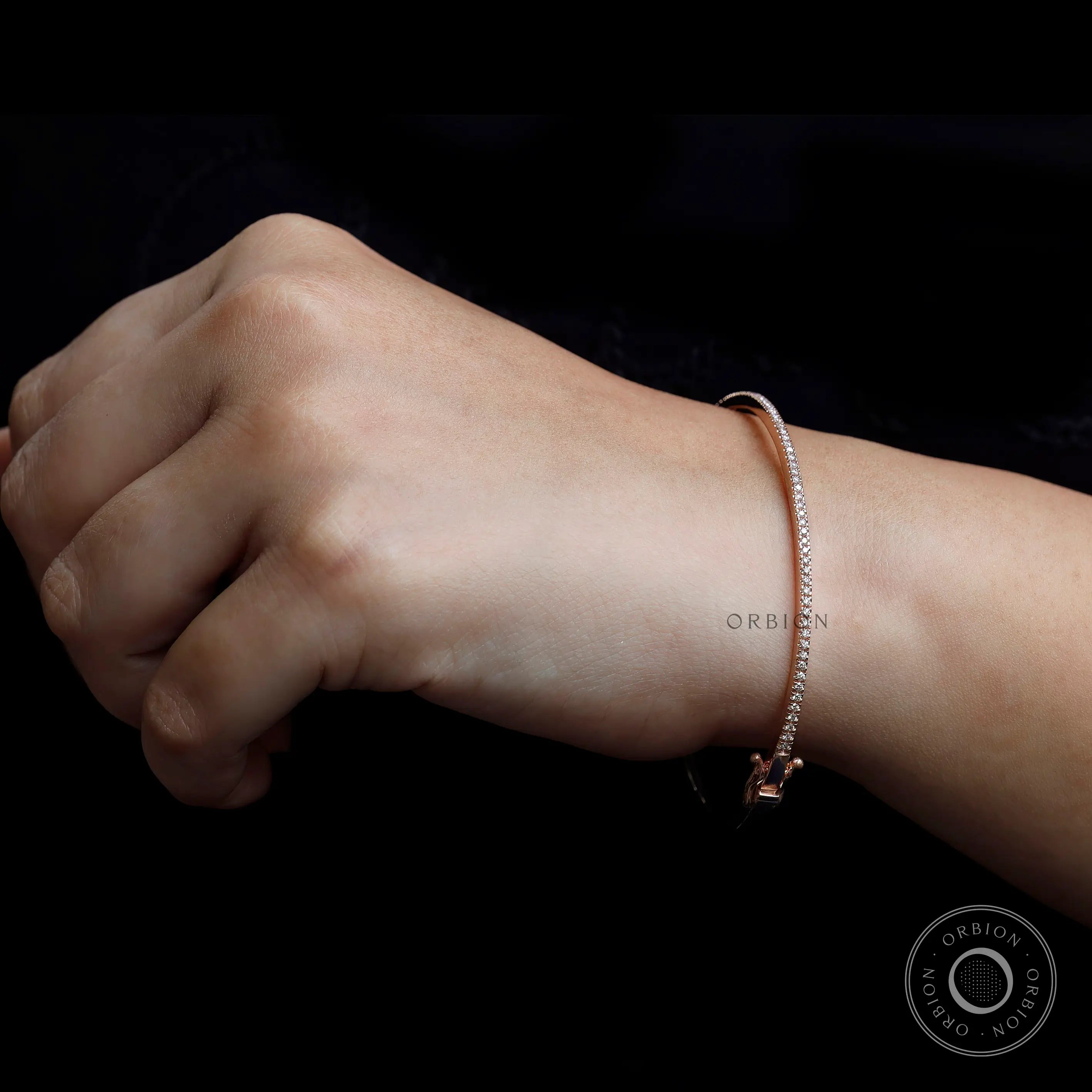 Dainty diamond bangle bracelet worn on wrist for size reference