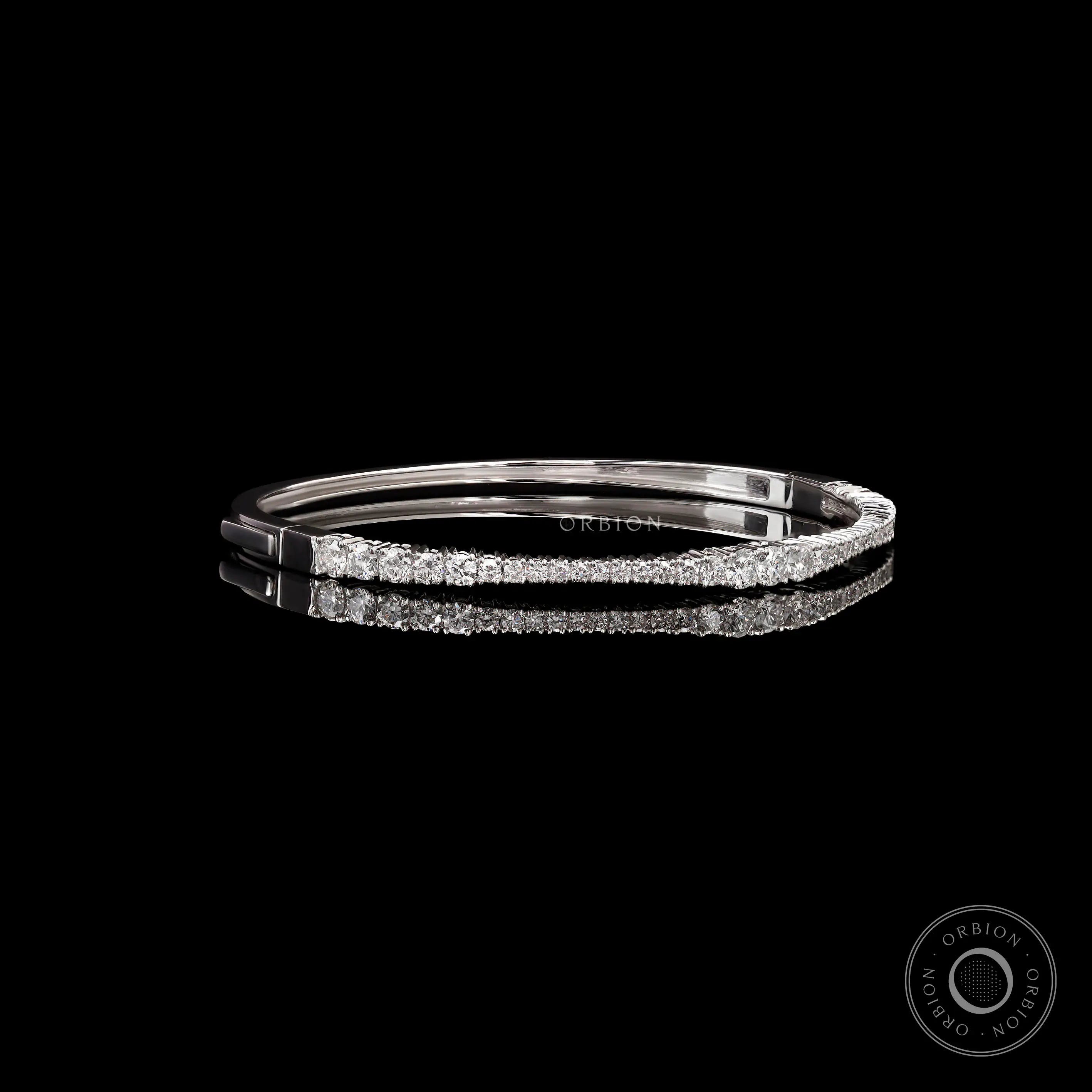 Angled side view of solid gold diamond bangle bracelet showing seamless lock