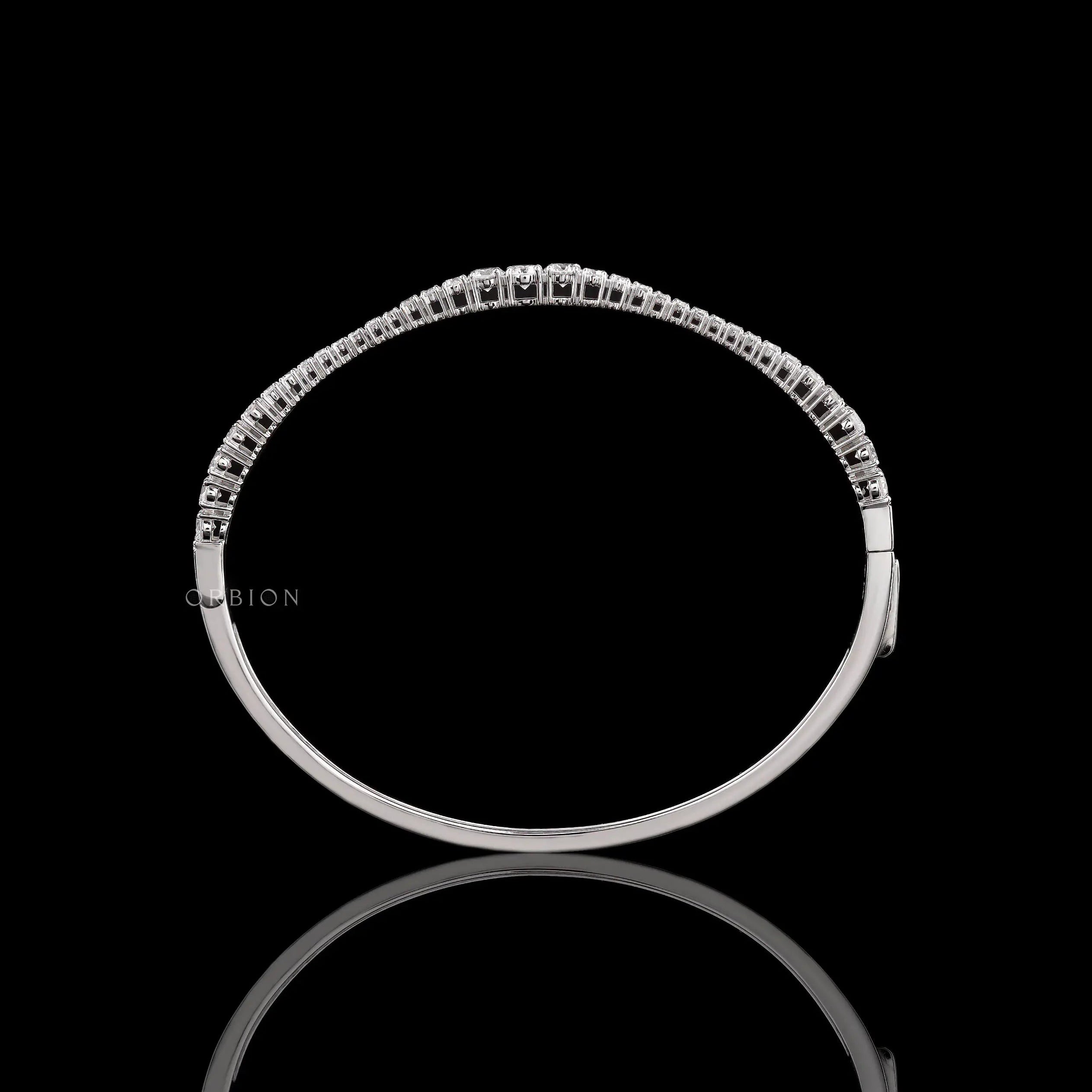 Top view of graduating lab grown diamond bangle bracelet highlighting diamond layout