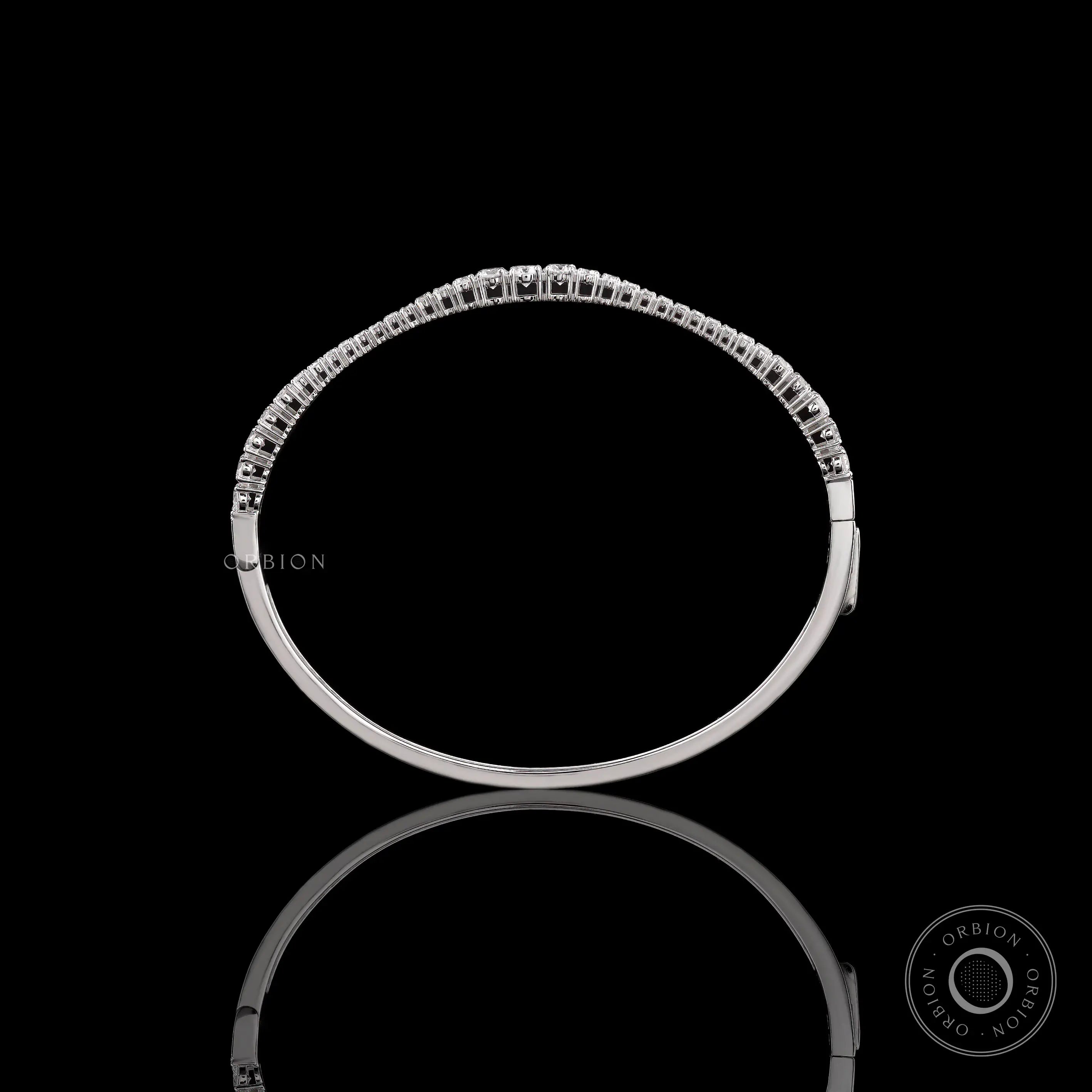 Top view of graduating lab grown diamond bangle bracelet highlighting diamond layout