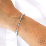 Everyday wear solid gold graduating diamond bangle bracelet on wrist