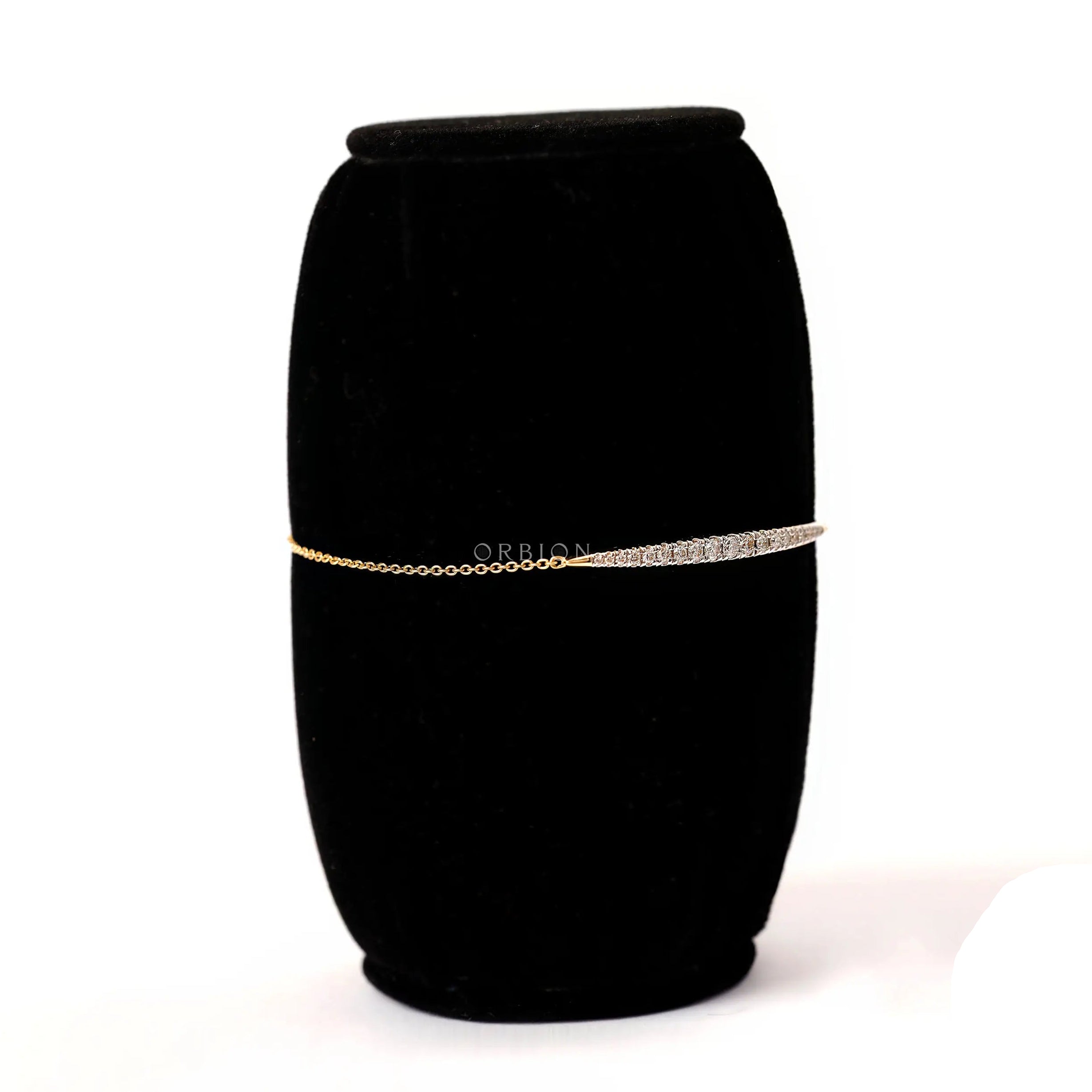 Angled side view of solid gold diamond bolo bracelet showing slim chain
