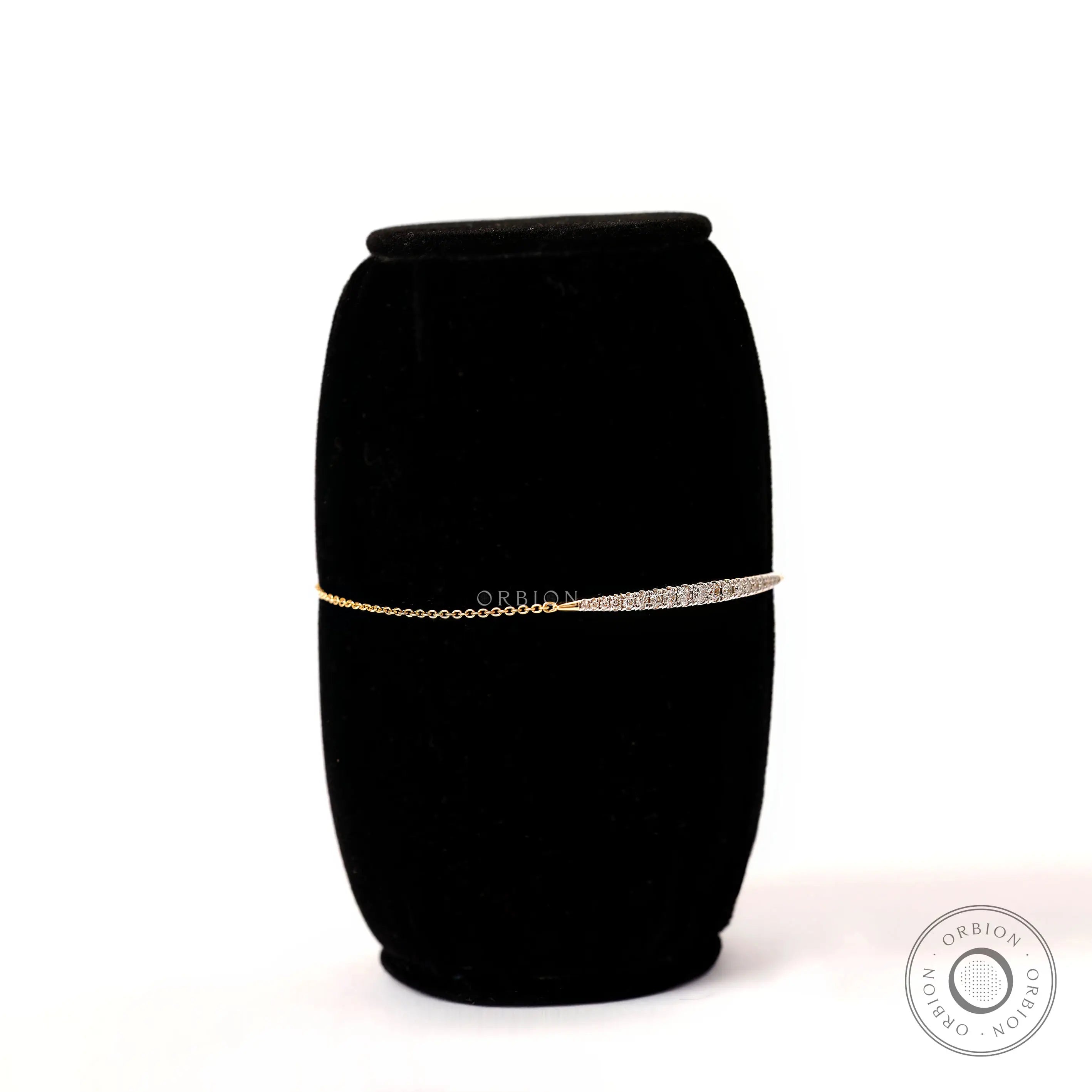 Angled side view of solid gold diamond bolo bracelet showing slim chain