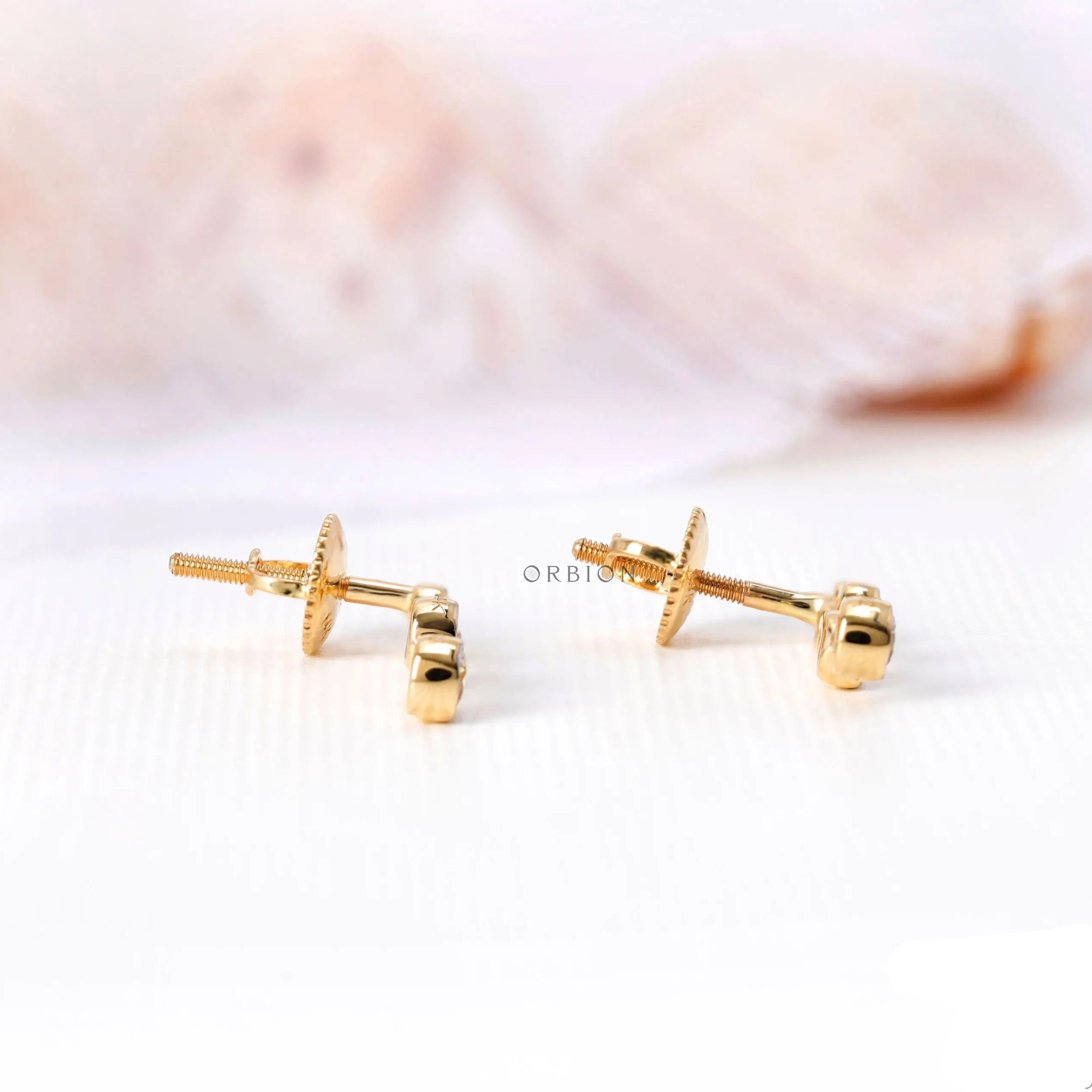 Diamond journey earrings graduated bezel set diamonds