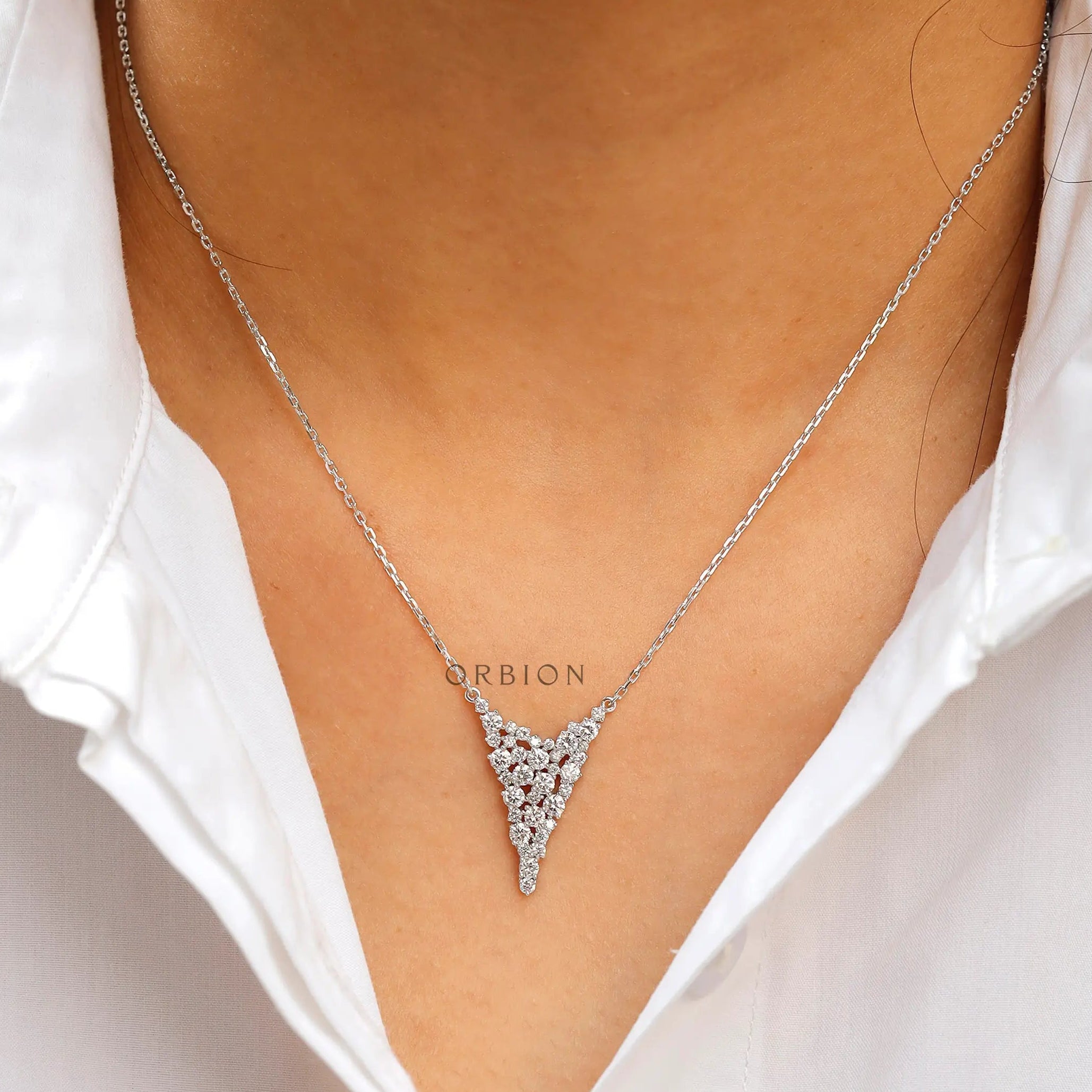Elegant diamond cluster waterfall necklace worn on neck