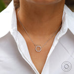 Everyday diamond circle necklace worn on neckline