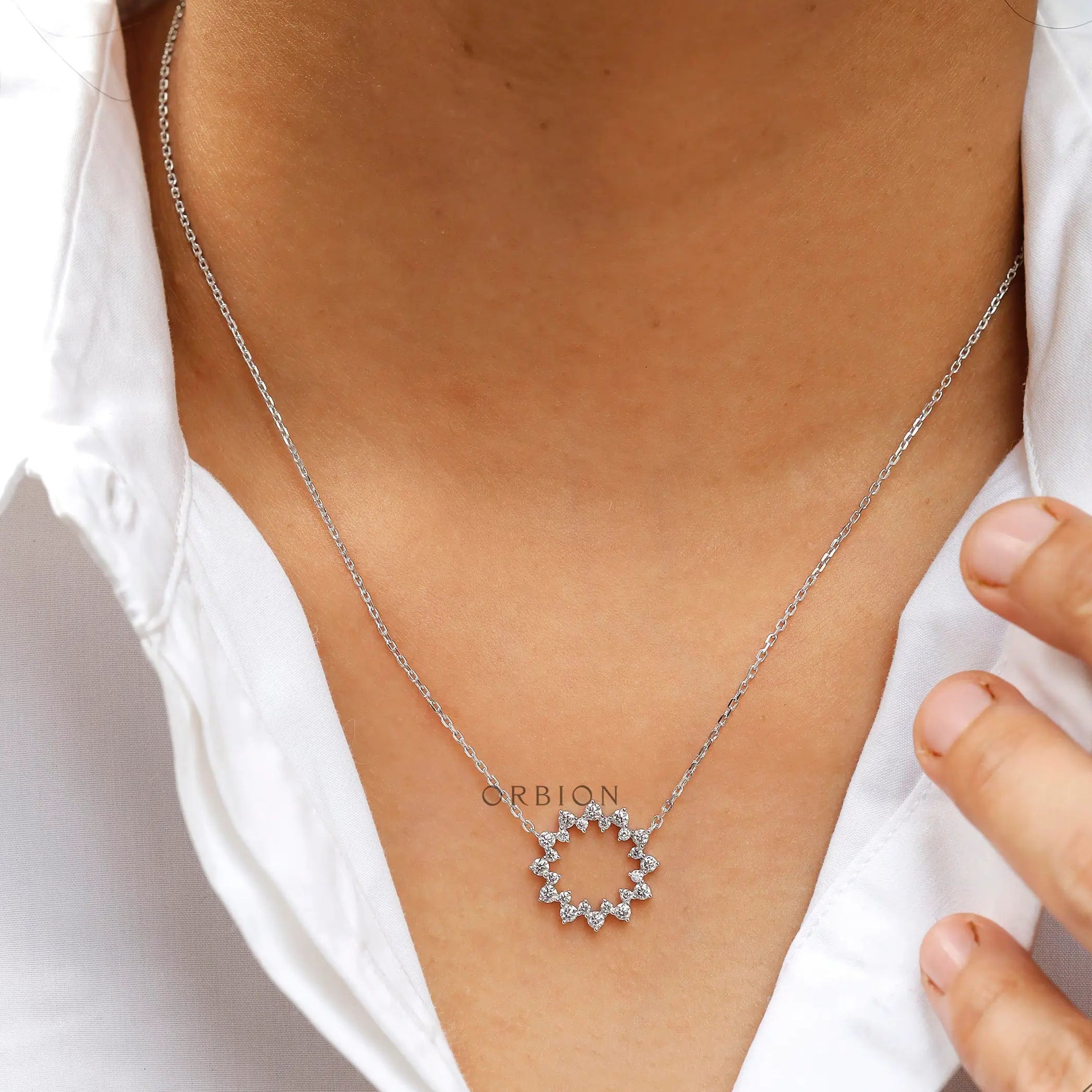 White gold diamond circle necklace on neckline