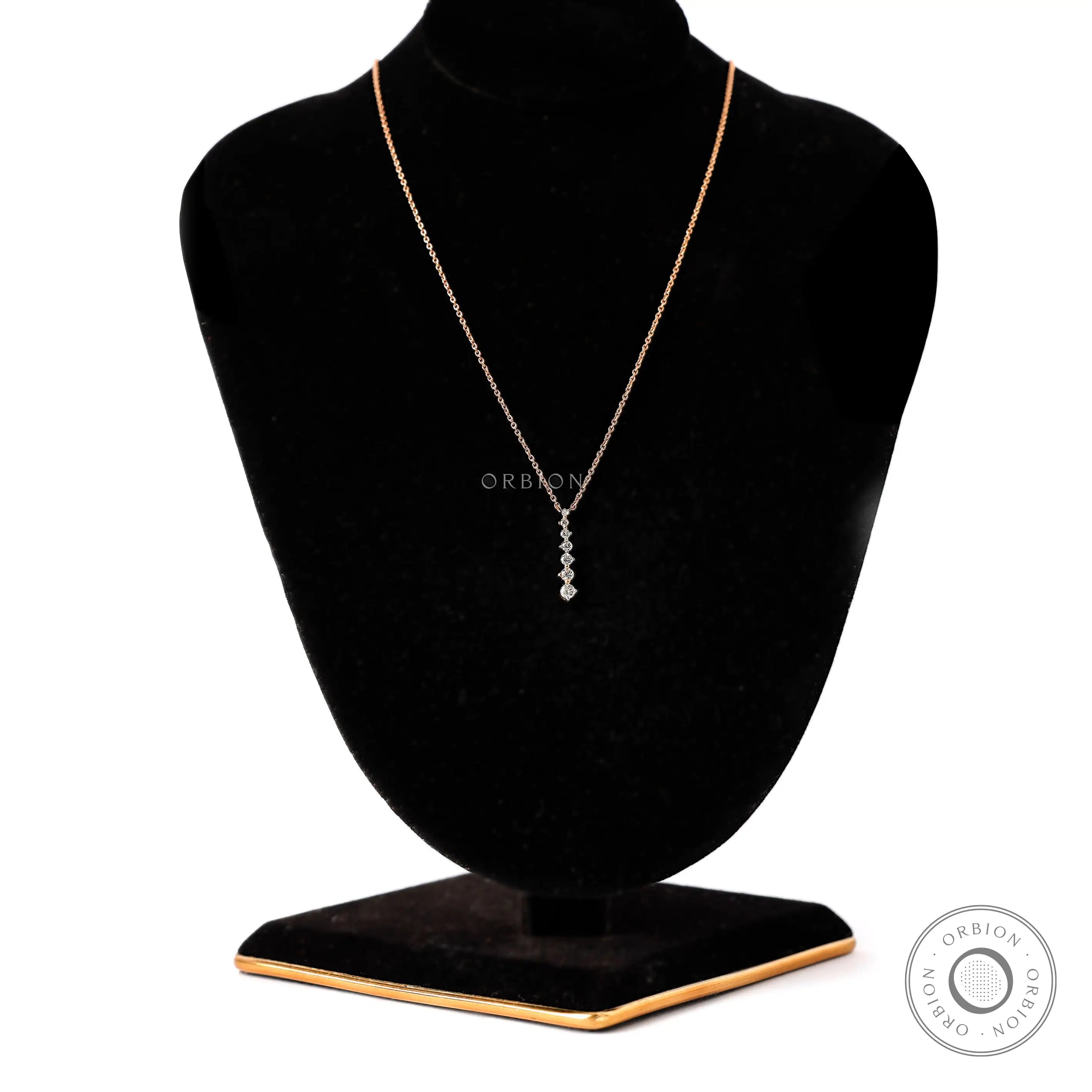 Necklace featuring a dainty design with brilliant diamonds set in 14k rose gold.