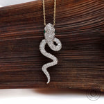 Solid gold pave diamond snake necklace charm macro detail