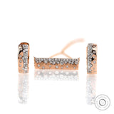 Close up of confetti bar pendant with matching earrings, diamonds set in rose gold