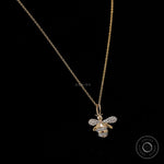 Close up of lab diamond pave honey bee charm in yellow gold