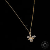 Close up of lab diamond pave honey bee charm in yellow gold