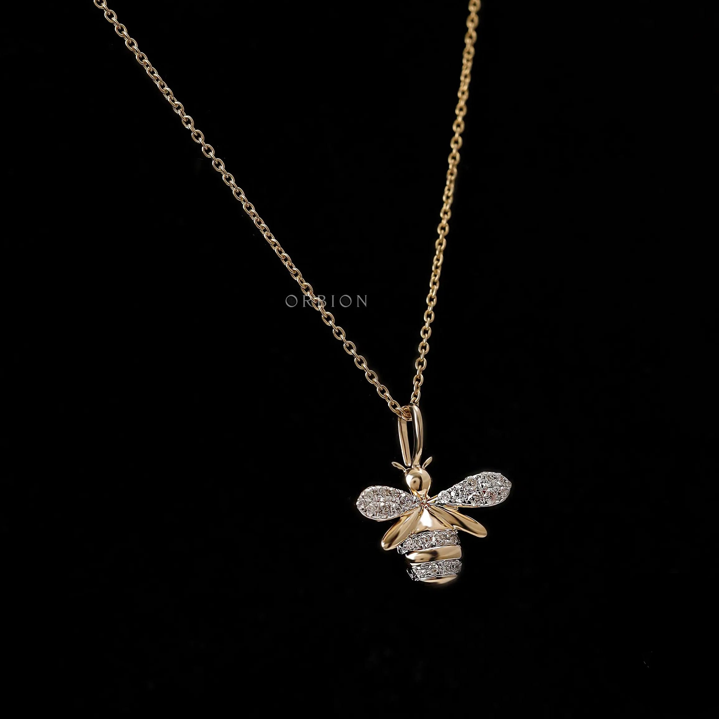 Close up of lab diamond pave honey bee charm in yellow gold