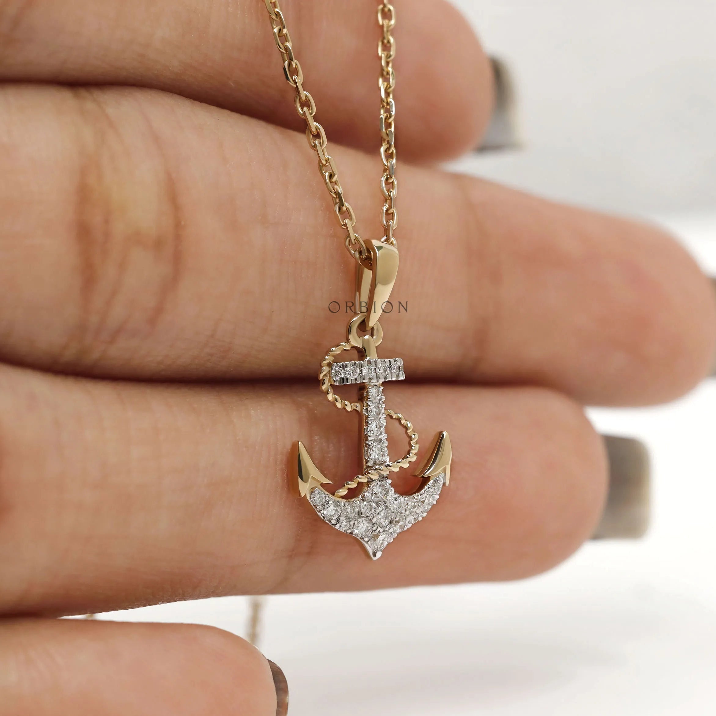 Yellow gold nautical necklace featuring anchor and rope design with lab diamonds