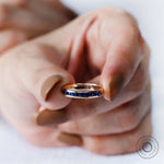 Blue sapphire half eternity ring on hand