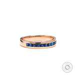 Blue sapphire channel set wedding band ring in rose gold