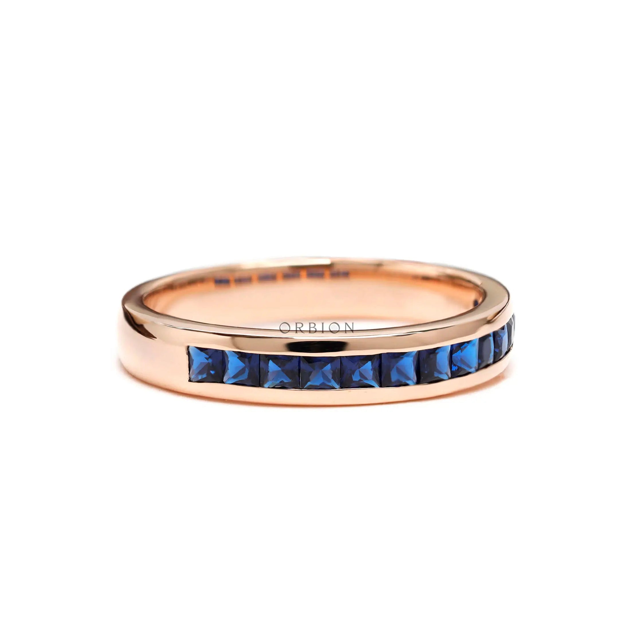 Blue sapphire channel set wedding band ring in rose gold