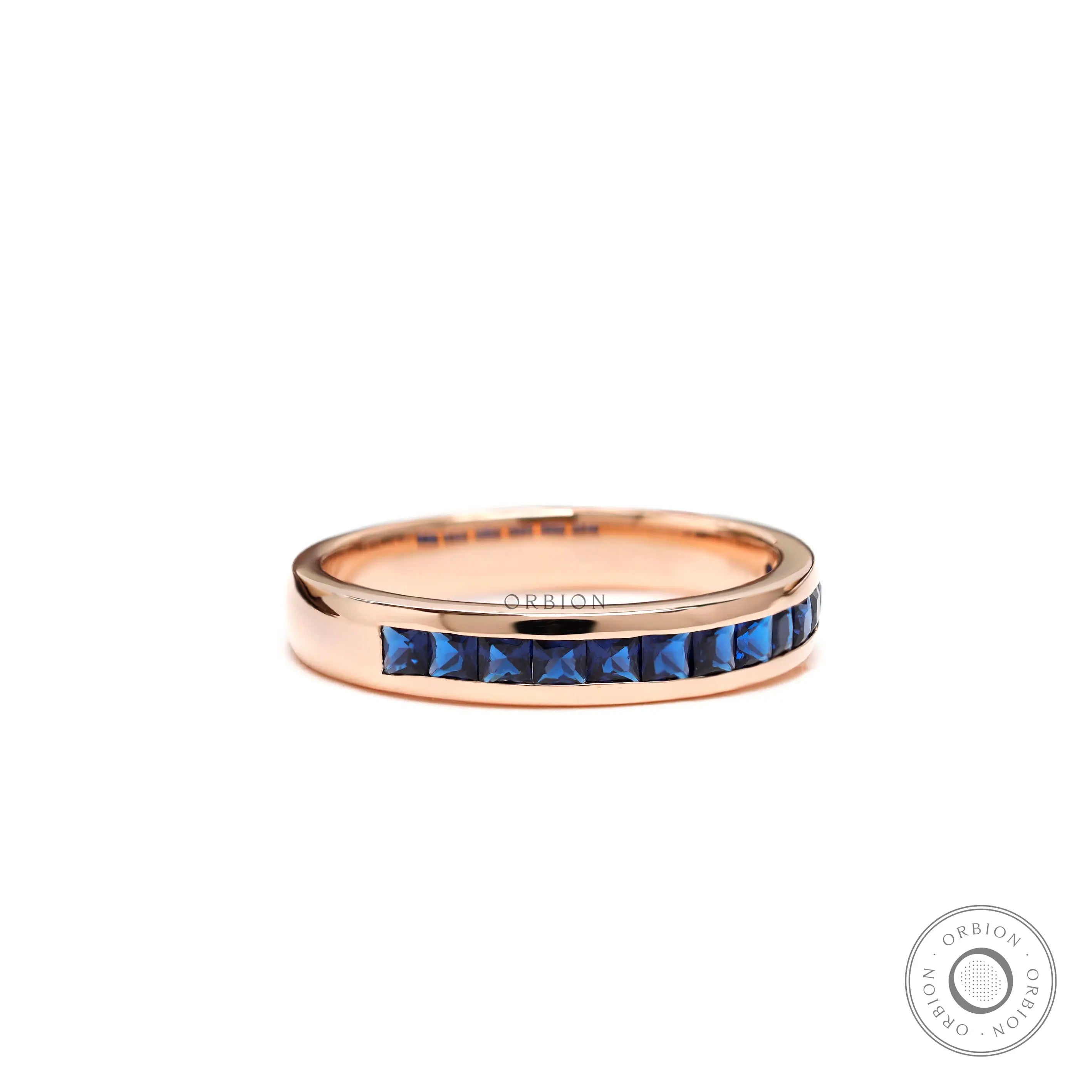 Blue sapphire channel set wedding band ring in rose gold