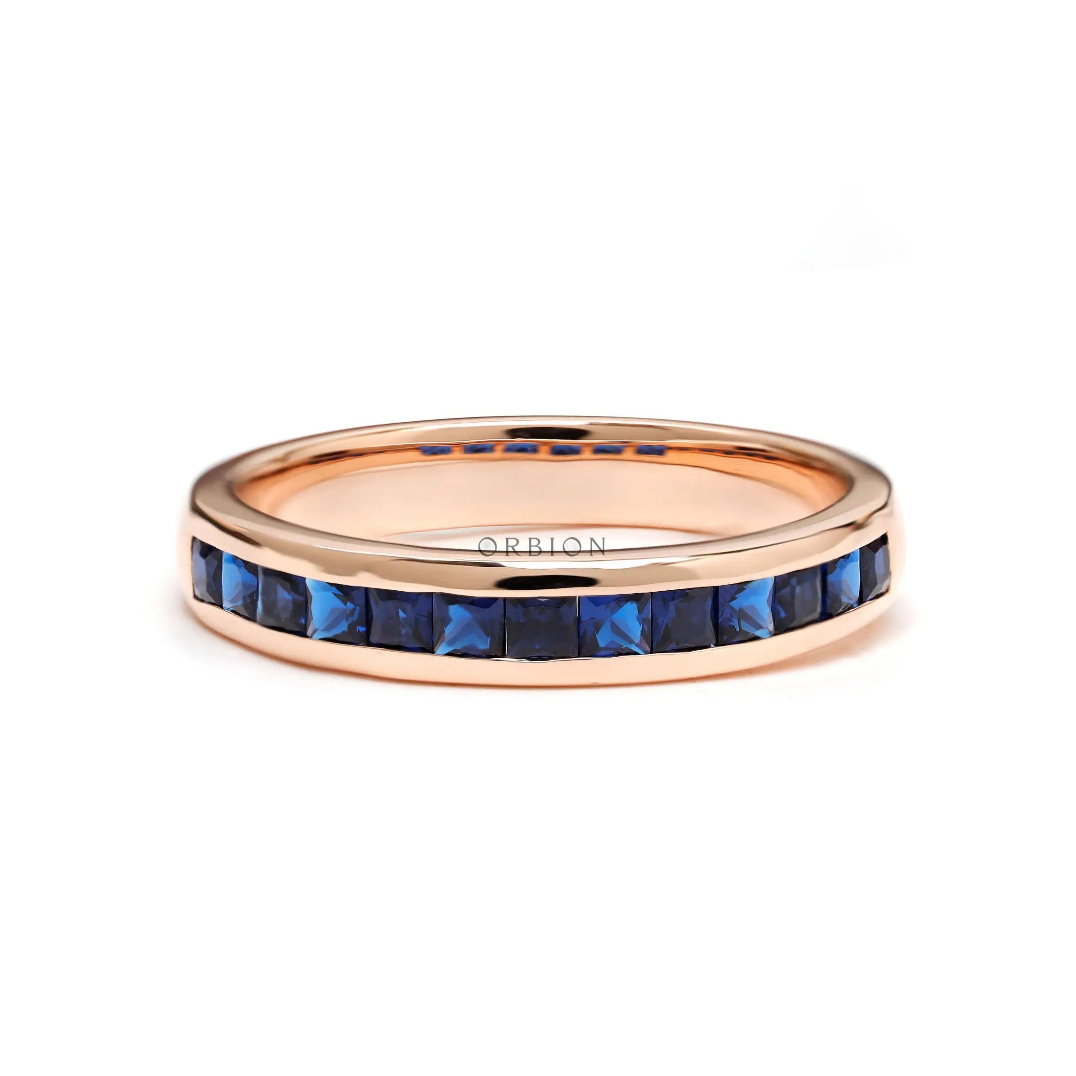Princess cut blue sapphire channel set half eternity band in 14k rose gold