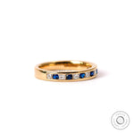 Alternating princess diamond and round sapphire channel set wedding band