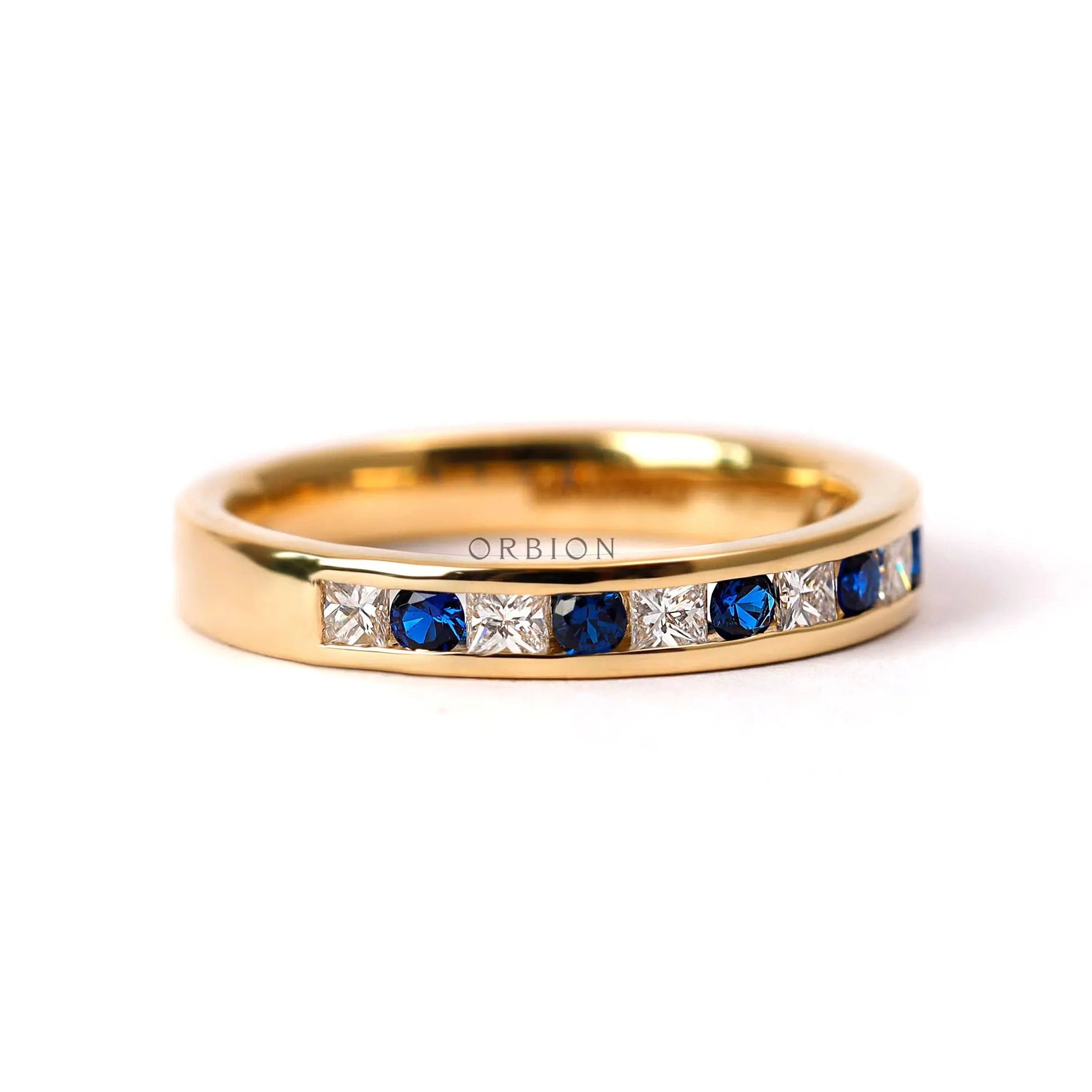 Alternating princess diamond and round sapphire channel set wedding band