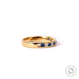 Diamond and blue sapphire half eternity band in yellow gold studio image