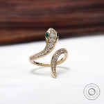 Serpent ring with channel set pave diamonds and emerald eyes