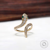Serpent ring with channel set pave diamonds and emerald eyes