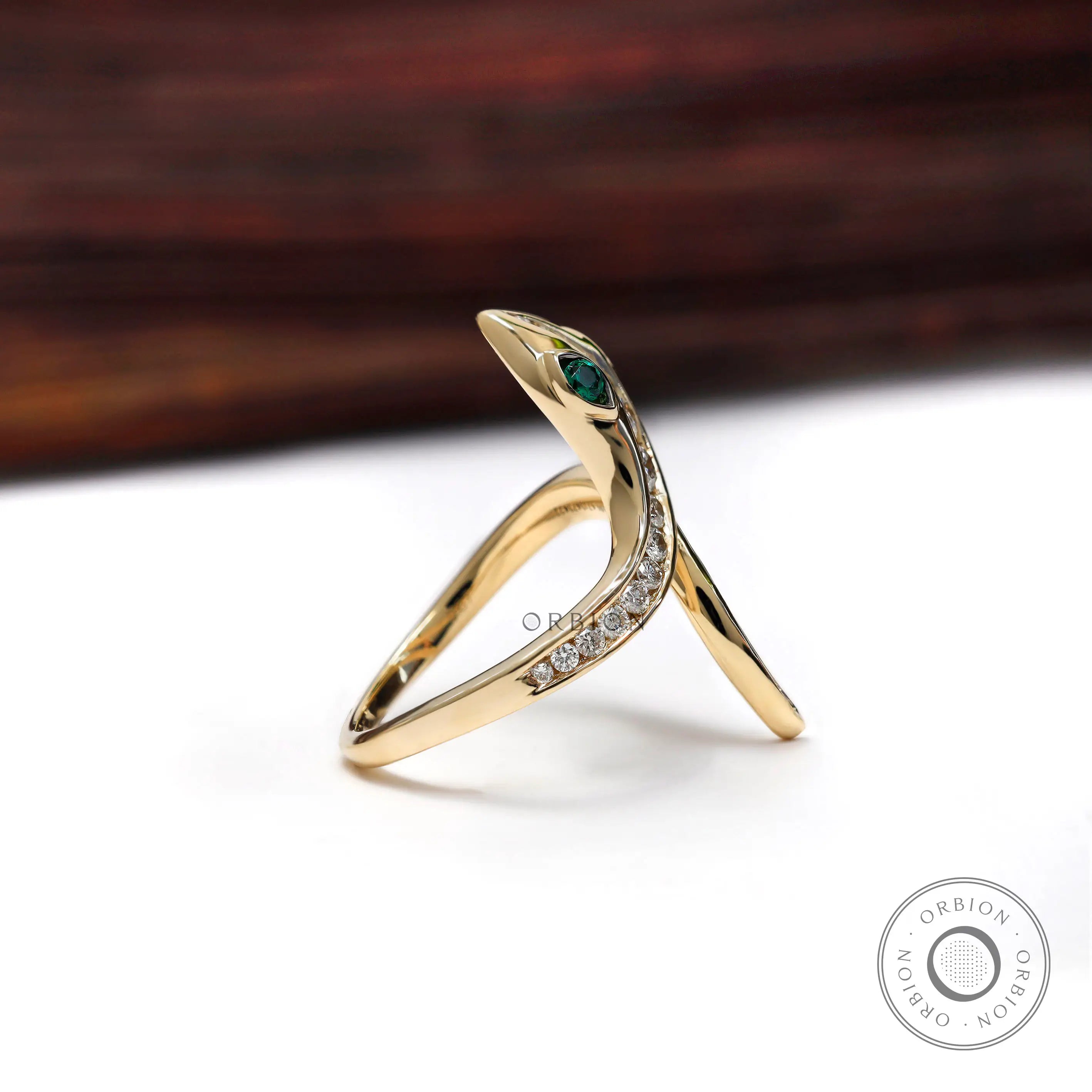 Solid gold snake ring showing curved band design