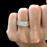 Diamond snowfall cigar band worn on finger for scale and fit reference