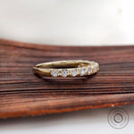 Angled view yellow gold round diamond half eternity band