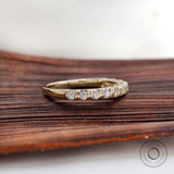 Angled view yellow gold round diamond half eternity band