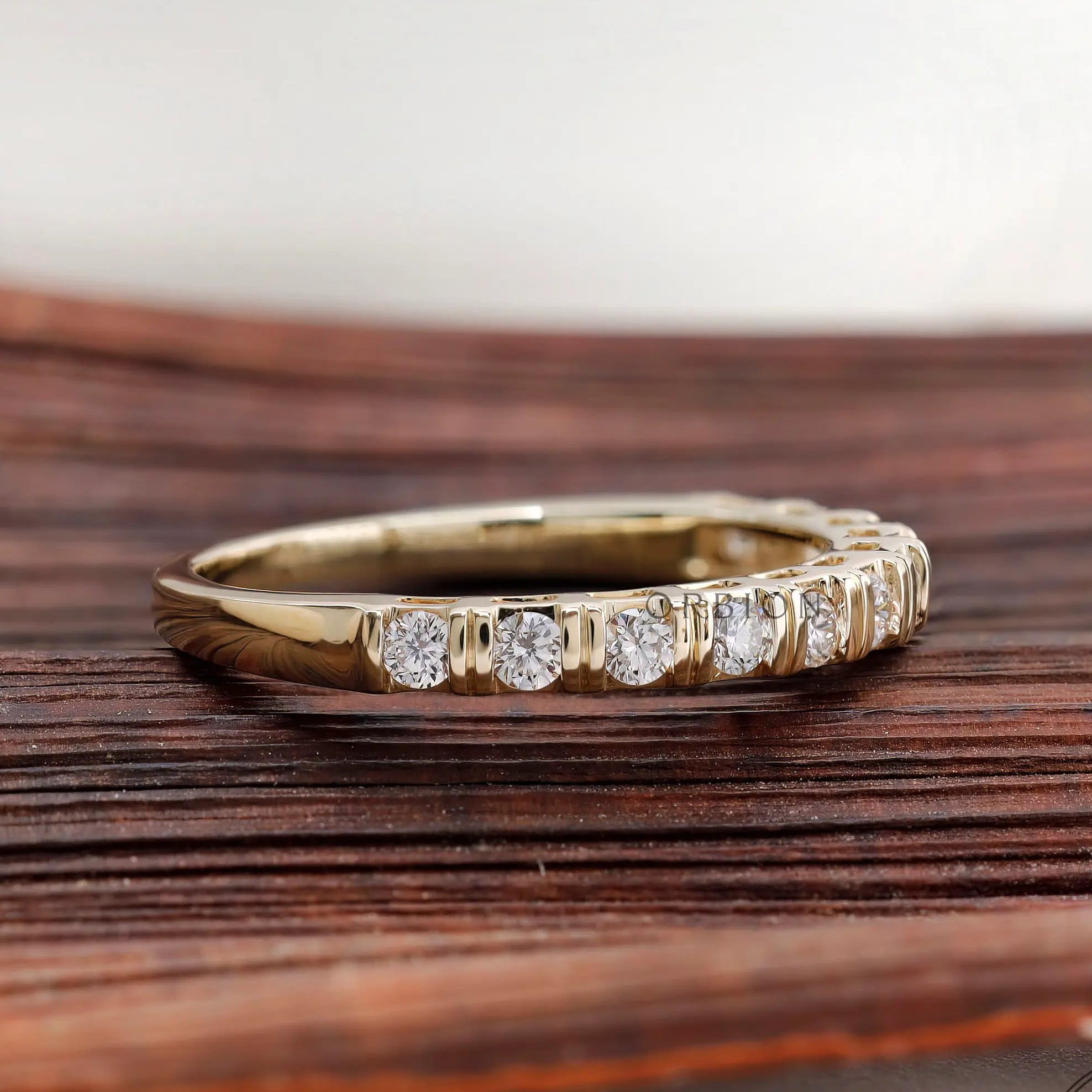 Angled view yellow gold round diamond half eternity band