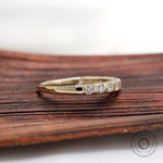 Side profile view yellow gold round diamond half eternity band