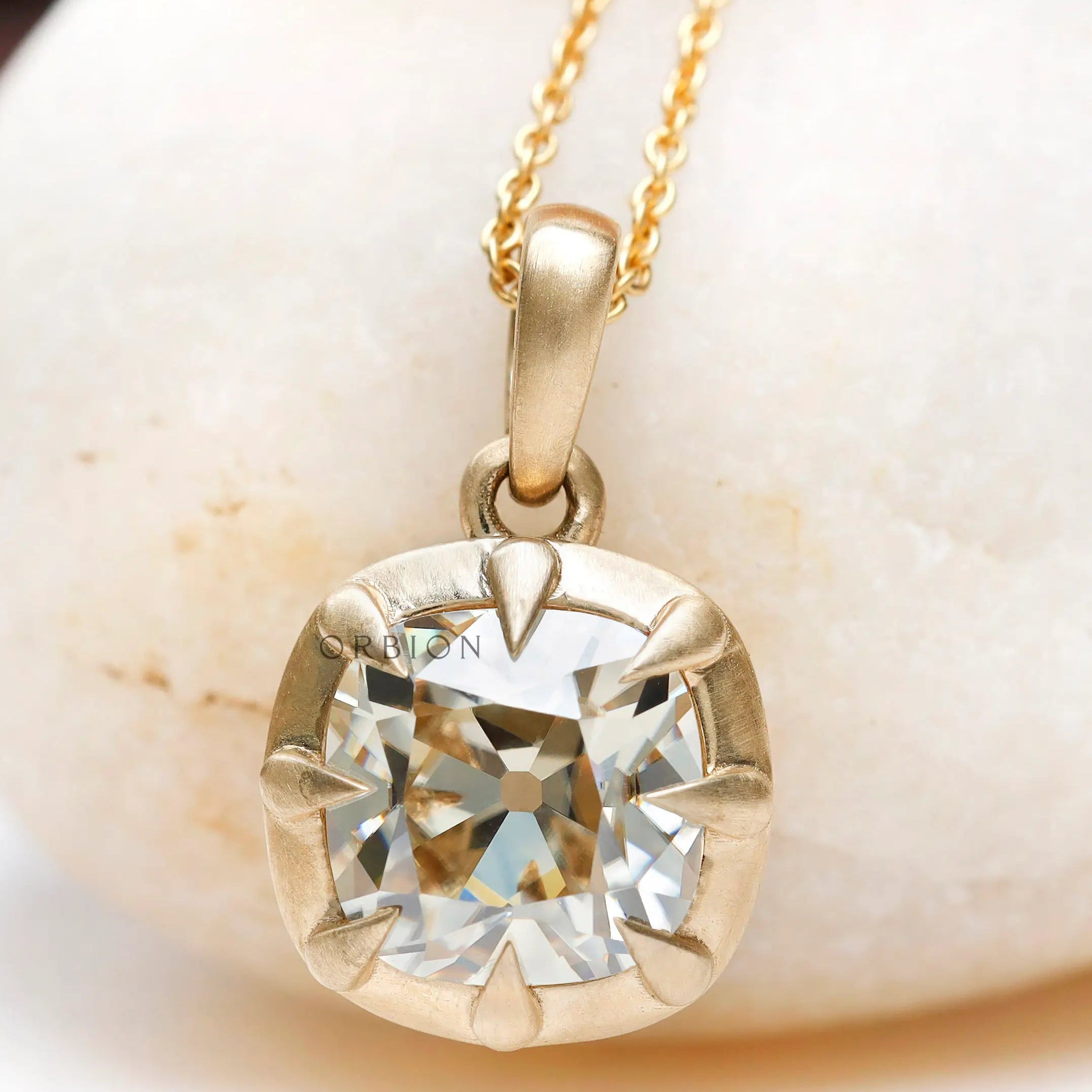 Off white cushion lab diamond pendant close up claw prong detail