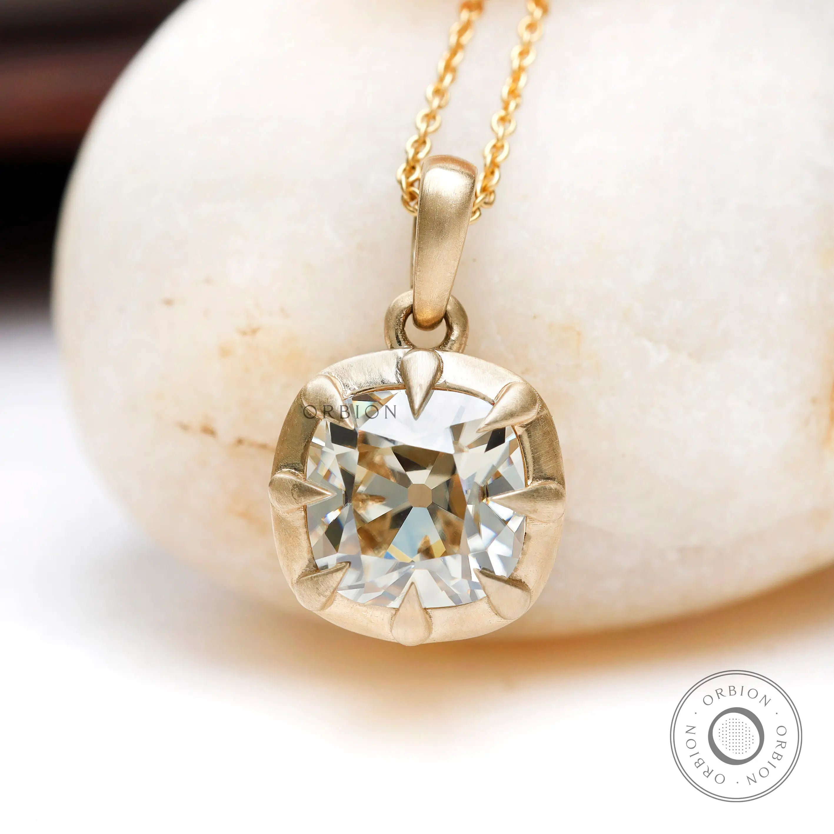 Off white cushion lab diamond pendant close up claw prong detail