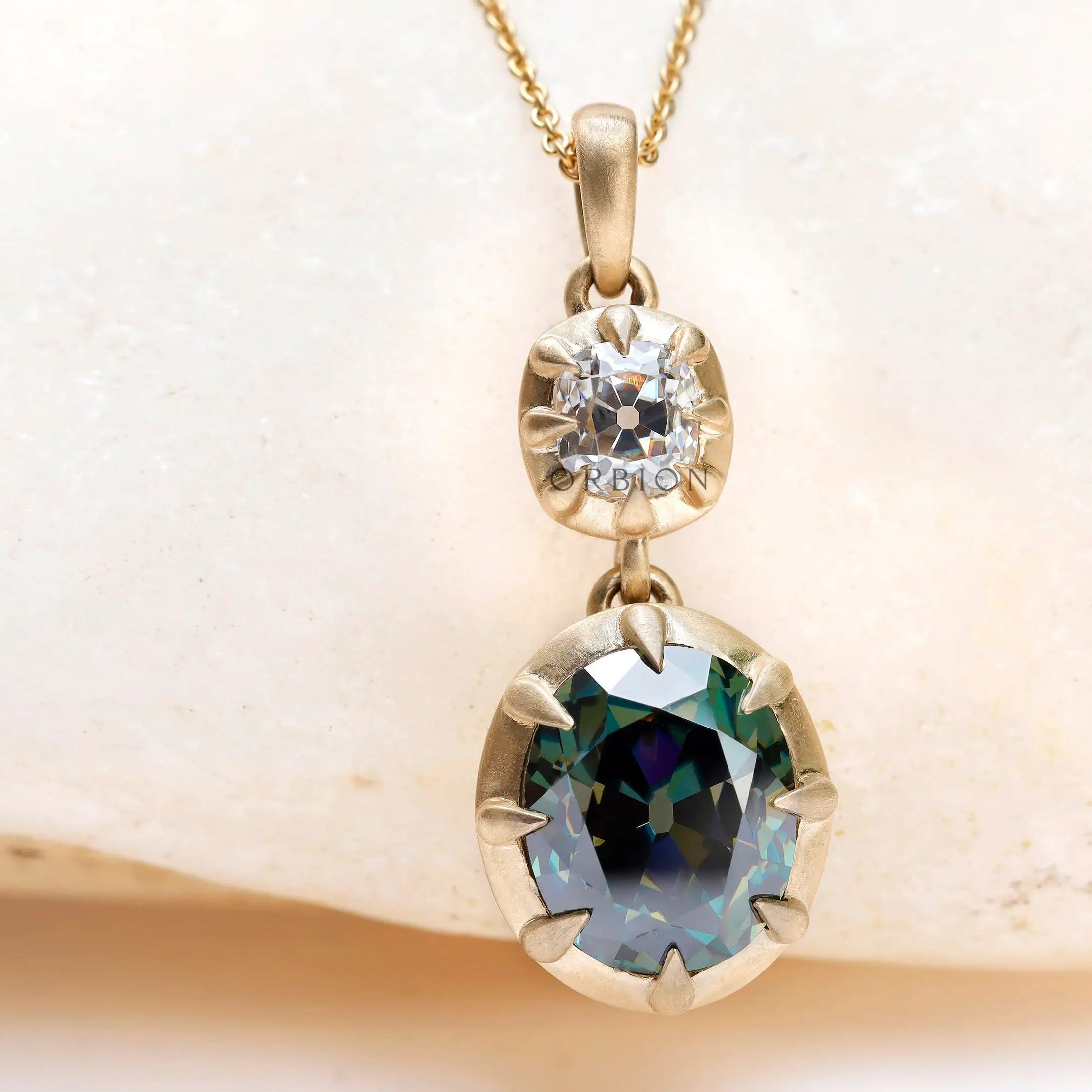 Two stone green and white moissanite drop pendant in 10K yellow gold
