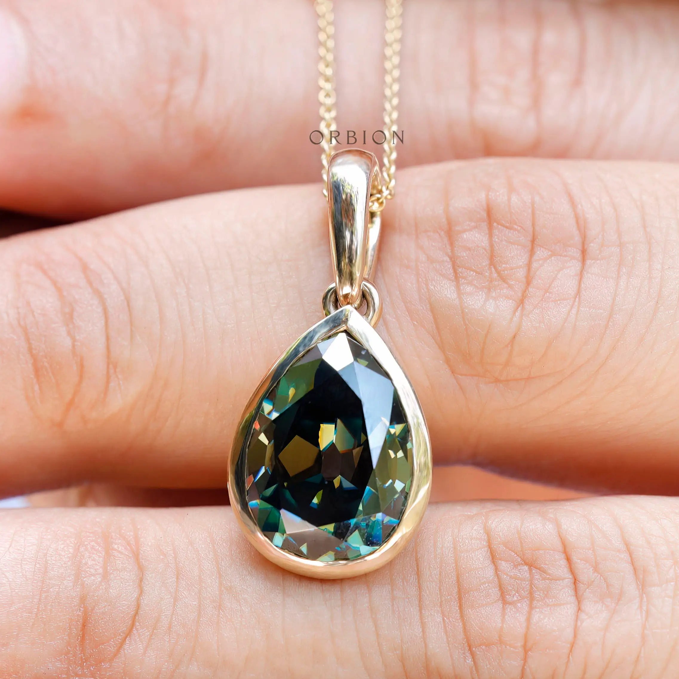 Dark green bezel set moissanite pendant close up