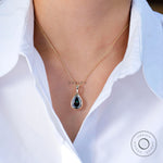 Statement green teardrop gold pendant on model