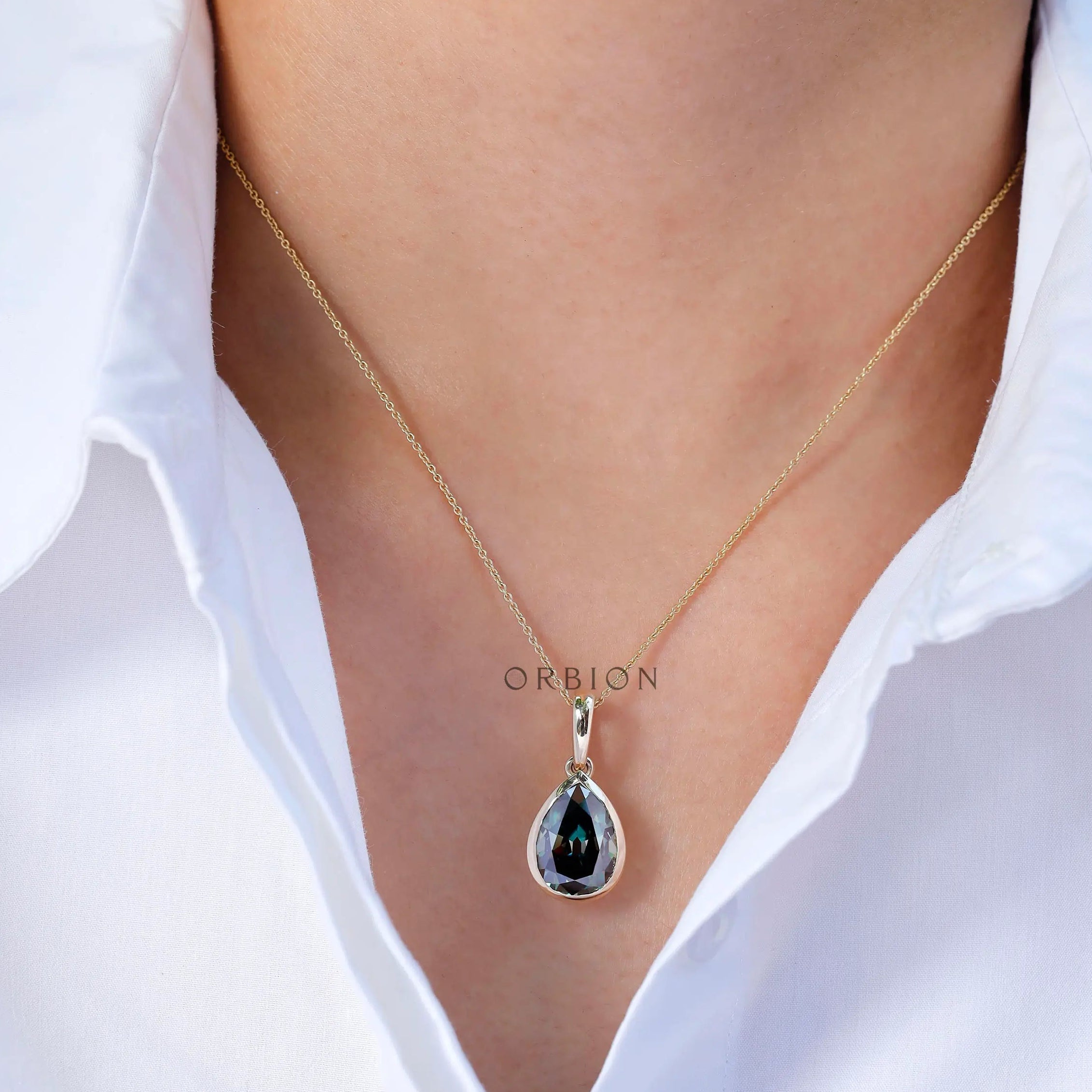 Statement green teardrop gold pendant on model
